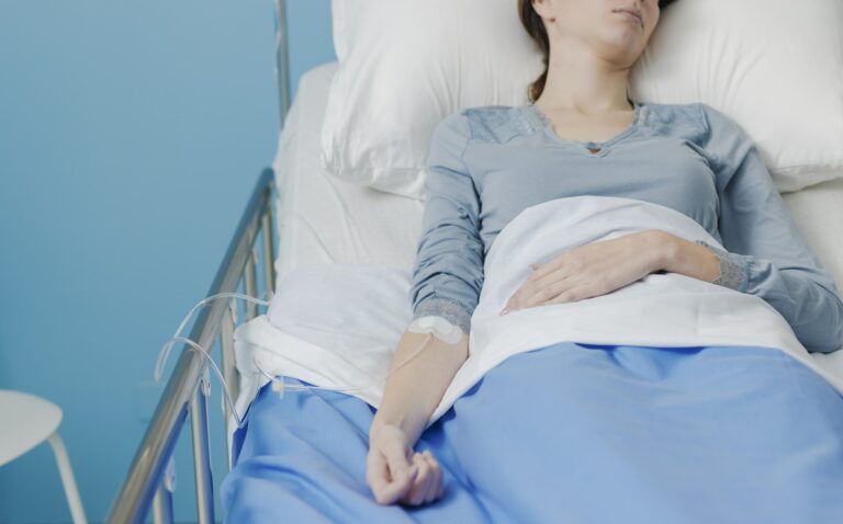 Patient in a hospital bed with IV drip